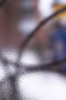 Water drops on glass window close up with blurred background. Drops in macro. Condensate on window closeup. Wet air.