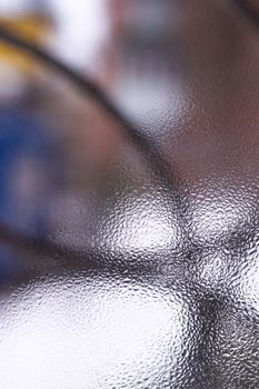 Water drops on glass window close up with blurred background. Drops in macro. Condensate on window closeup. Wet air.