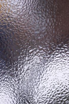 Water drops on glass window close up with blurred background. Drops in macro. Condensate on window closeup. Wet air.