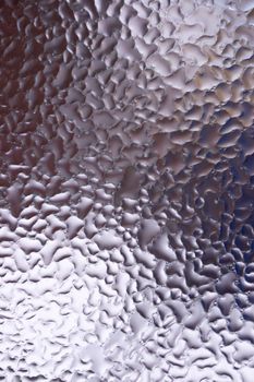 Water drops on glass window close up with blurred background. Drops in macro. Condensate on window closeup. Wet air.