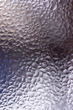 Water drops on glass window close up with blurred background. Drops in macro. Condensate on window closeup. Wet air.