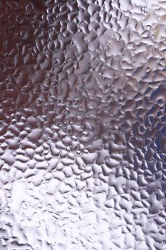Water drops on glass window close up with blurred background. Drops in macro. Condensate on window closeup. Wet air.