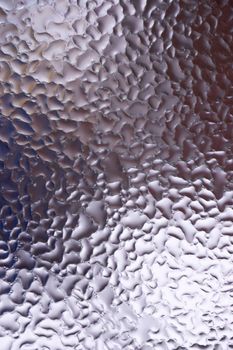 Water drops on glass window close up with blurred background. Drops in macro. Condensate on window closeup. Wet air.