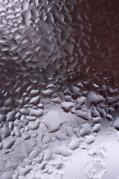 Water drops on glass window close up with blurred background. Drops in macro. Condensate on window closeup. Wet air.