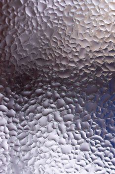Water drops on glass window close up with blurred background. Drops in macro. Condensate on window closeup. Wet air.