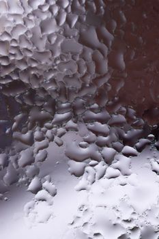 Water drops on glass window close up with blurred background. Drops in macro. Condensate on window closeup. Wet air.