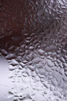 Water drops on glass window close up with blurred background. Drops in macro. Condensate on window closeup. Wet air.