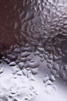Water drops on glass window close up with blurred background. Drops in macro. Condensate on window closeup. Wet air.