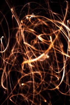 Long exposure underexposed photo of lightpainting bengali fire. Lighdrawing photo. Soft focus and a lot of lines.