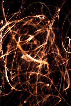 Long exposure underexposed photo of lightpainting bengali fire. Lighdrawing photo. Soft focus and a lot of lines.