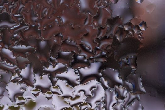 Water drops on glass window close up with blurred background. Drops in macro. Condensate on window closeup. Wet air.