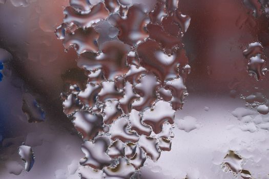 Water drops on glass window close up with blurred background. Drops in macro. Condensate on window closeup. Wet air.