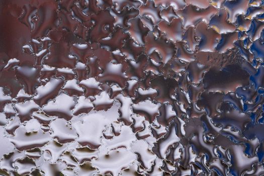 Water drops on glass window close up with blurred background. Drops in macro. Condensate on window closeup. Wet air.