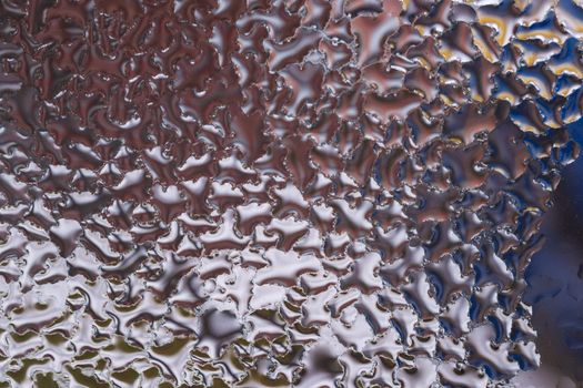 Water drops on glass window close up with blurred background. Drops in macro. Condensate on window closeup. Wet air.