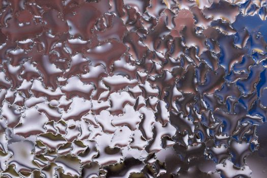 Water drops on glass window close up with blurred background. Drops in macro. Condensate on window closeup. Wet air.