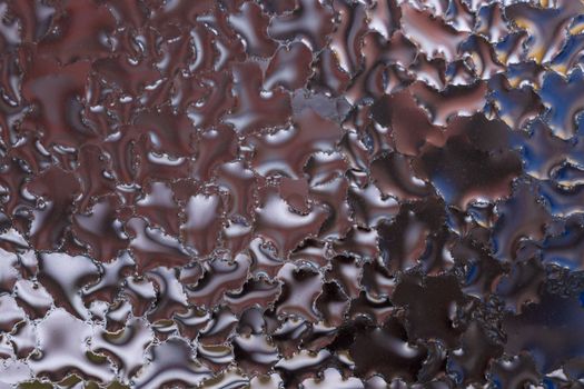 Water drops on glass window close up with blurred background. Drops in macro. Condensate on window closeup. Wet air.