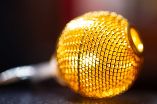 Battery garland with metallic grid balls on blurred background. Closeup view.