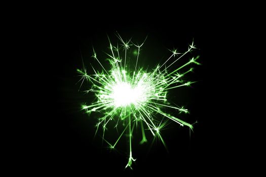Low light photo of bengali fire isolated on black background with green toning. A lot of light and sparks. Underexposed photo.