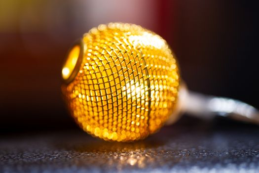 Battery garland with metallic grid balls on blurred background. Closeup view.