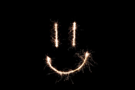 Long exposure underexposed photo of lightpainting bengali fire. Lighdrawing photo. Soft focus and a lot of lines. Smile on photo
