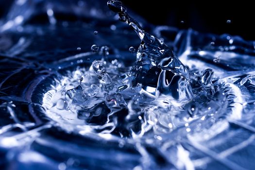 Water drops splashing on acoustic membrane. A lot of drops in air. High frequency of sound waves. Water cloud small drops. Frozen time shot.