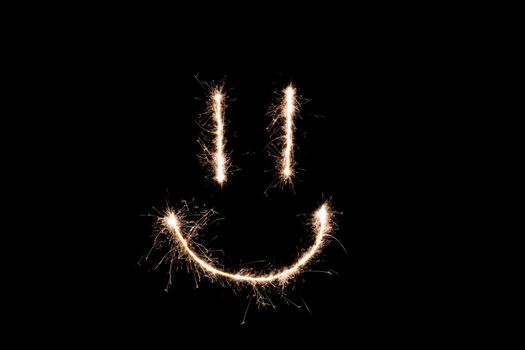 Long exposure underexposed photo of lightpainting bengali fire. Lighdrawing photo. Soft focus and a lot of lines. Smile on photo