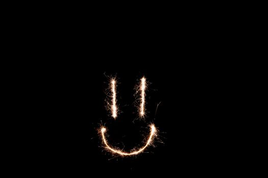 Long exposure underexposed photo of lightpainting bengali fire. Lighdrawing photo. Soft focus and a lot of lines. Smile on photo