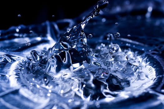 Water drops splashing on acoustic membrane. A lot of drops in air. High frequency of sound waves. Water cloud small drops. Frozen time shot.