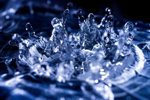 Water drops splashing on acoustic membrane. A lot of drops in air. High frequency of sound waves. Water cloud small drops. Frozen time shot.
