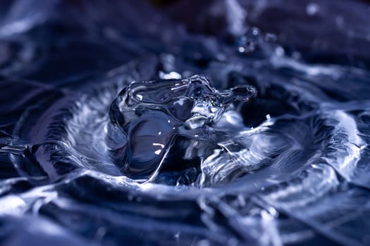 Water drops splashing on acoustic membrane. A lot of drops in air. High frequency of sound waves. Water cloud small drops. Frozen time shot.