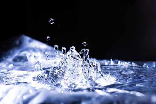 Water drops splashing on acoustic membrane. A lot of drops in air. High frequency of sound waves. Water cloud small drops. Frozen time shot. 