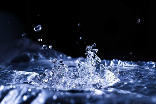 Water drops splashing on acoustic membrane. A lot of drops in air. High frequency of sound waves. Water cloud small drops. Frozen time shot. 