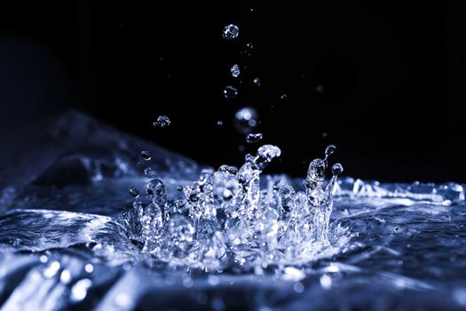 Water drops splashing on acoustic membrane. A lot of drops in air. High frequency of sound waves. Water cloud small drops. Frozen time shot. 