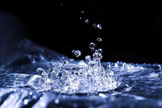 Water drops splashing on acoustic membrane. A lot of drops in air. High frequency of sound waves. Water cloud small drops. Frozen time shot. 