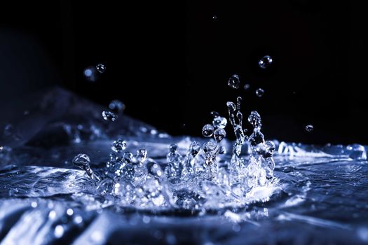 Water drops splashing on acoustic membrane. A lot of drops in air. High frequency of sound waves. Water cloud small drops. Frozen time shot. 