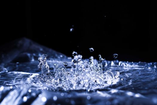 Water drops splashing on acoustic membrane. A lot of drops in air. High frequency of sound waves. Water cloud small drops. Frozen time shot. 