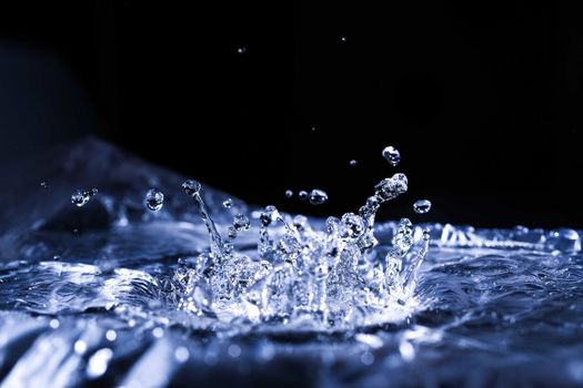 Water drops splashing on acoustic membrane. A lot of drops in air. High frequency of sound waves. Water cloud small drops. Frozen time shot. 