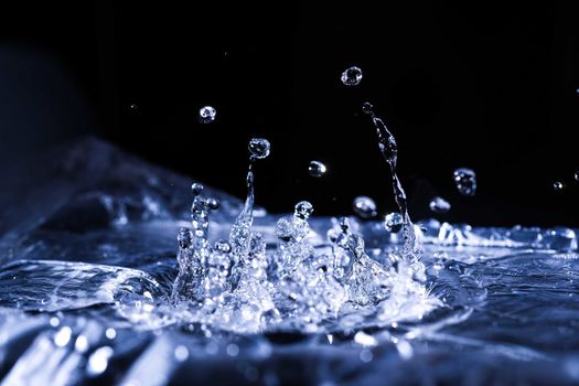 Water drops splashing on acoustic membrane. A lot of drops in air. High frequency of sound waves. Water cloud small drops. Frozen time shot. 