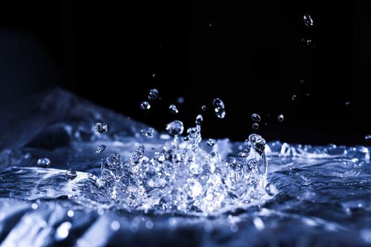 Water drops splashing on acoustic membrane. A lot of drops in air. High frequency of sound waves. Water cloud small drops. Frozen time shot. 