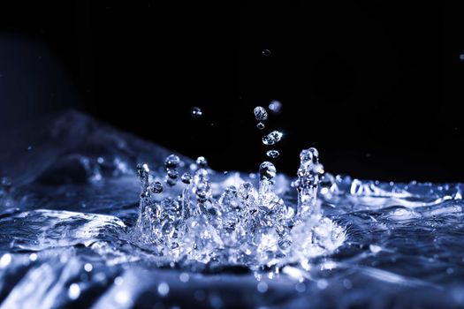 Water drops splashing on acoustic membrane. A lot of drops in air. High frequency of sound waves. Water cloud small drops. Frozen time shot. 
