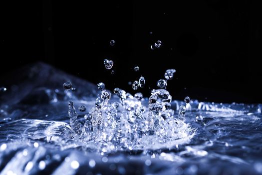 Water drops splashing on acoustic membrane. A lot of drops in air. High frequency of sound waves. Water cloud small drops. Frozen time shot. 