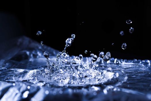 Water drops splashing on acoustic membrane. A lot of drops in air. High frequency of sound waves. Water cloud small drops. Frozen time shot.