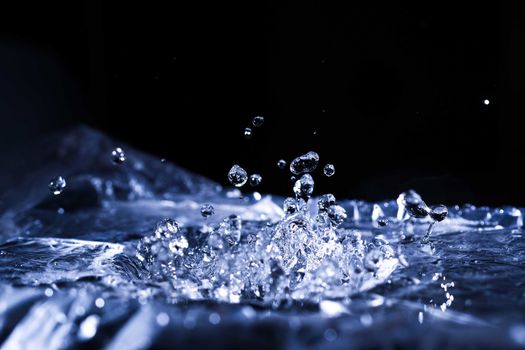 Water drops splashing on acoustic membrane. A lot of drops in air. High frequency of sound waves. Water cloud small drops. Frozen time shot. 
