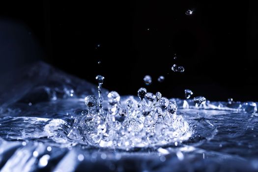 Water drops splashing on acoustic membrane. A lot of drops in air. High frequency of sound waves. Water cloud small drops. Frozen time shot. 