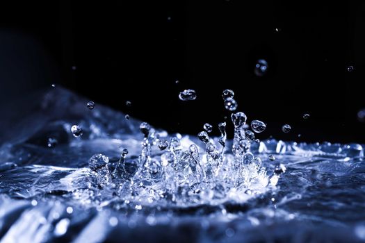 Water drops splashing on acoustic membrane. A lot of drops in air. High frequency of sound waves. Water cloud small drops. Frozen time shot. 