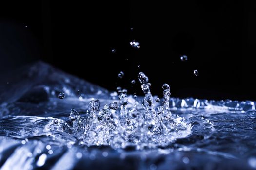 Water drops splashing on acoustic membrane. A lot of drops in air. High frequency of sound waves. Water cloud small drops. Frozen time shot.