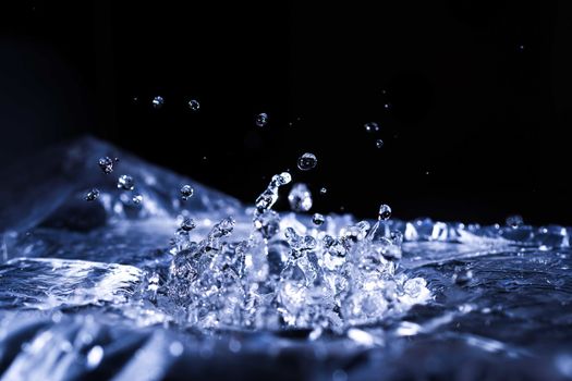 Water drops splashing on acoustic membrane. A lot of drops in air. High frequency of sound waves. Water cloud small drops. Frozen time shot. 