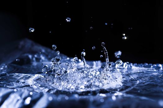 Water drops splashing on acoustic membrane. A lot of drops in air. High frequency of sound waves. Water cloud small drops. Frozen time shot. 