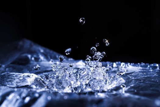 Water drops splashing on acoustic membrane. A lot of drops in air. High frequency of sound waves. Water cloud small drops. Frozen time shot.