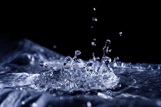 Water drops splashing on acoustic membrane. A lot of drops in air. High frequency of sound waves. Water cloud small drops. Frozen time shot. 